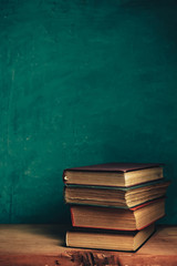 Aufkleber - Old books on a old red wooden table. Beautiful Green wall background.