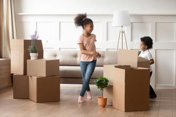 Wall Mural - Happy african american kids playing near cardboard boxes.