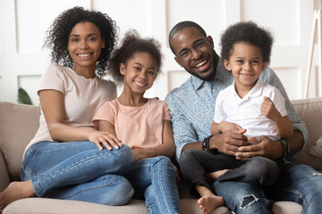 Wall Mural - Happy cute black family of four portrait.