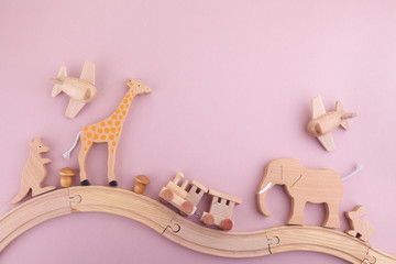 zero waste. eco wooden toys on pink background. flat lay. top view