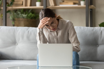 Exhausted annoyed young woman received bad news notification.