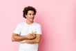 © Asier - Young caucasian curly man  holding a magic lamp smiling confident with crossed arms.