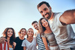 © HBS - Group of happy teenage friends taking selfie on nature. Young woman with american flag background.