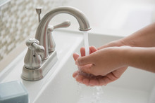 Close-up Of Woman Washing Hands In Bathroom Sink.