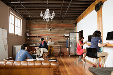 Entrepreneurs Working In Creative Office Space
