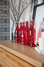 Red Glass Accent Bottles On Counter