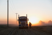 Truck Driver Near Semi-truck In Rural Field