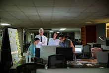 Business People Working Late At Computer In Office
