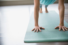 Woman Practicing Yoga On Mat In Plank Pose