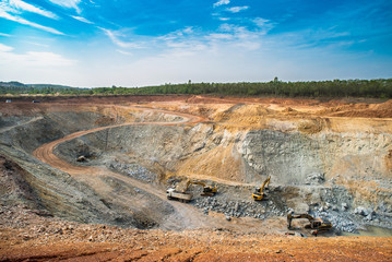 Wall Mural - Aerial view of opencast mining quarry with lots of machinery at work - view from above.This area has been mined for copper, silver, gold, and other minerals,Thailand
