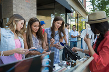 Women Browsing Merchandise At Sidewalk Sale