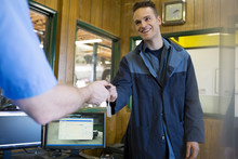 Mechanics Exchanging Keys Auto Shop Office