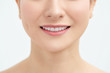 © makistock - Beautiful young woman with healthy teeth on white background