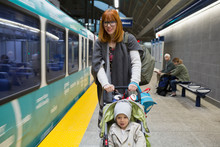Mother Pushing Son In Stroller Subway Station Platform