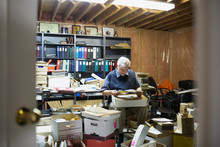 Senior Man Reading Old Letters In Boxes