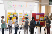 Elementary Students With Projects At Science Fair