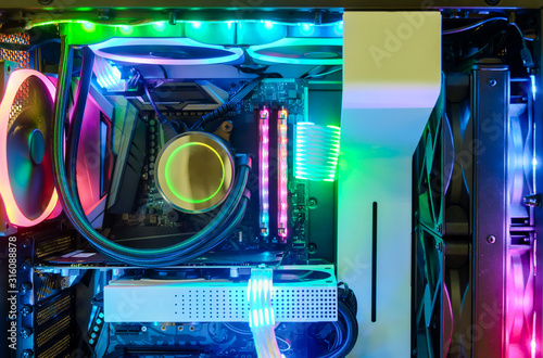 Close-up and inside Desktop PC Gaming and Cooling Fan CPU system with multicolored LED RGB light show status on working mode, interior PC Case technology background