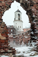 View of the clock tower from the window of the destroyed Church, Vyborg, Russia, winter