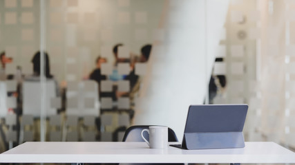 Canvas Print - close up view of workspace with digital tablet, coffee cup and copy space on white table with blurre
