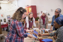 Instructor Teaching Women In Mosaic Art And Craft Class