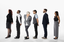 Business People Standing In A Row, Waiting In Queue Against White Background