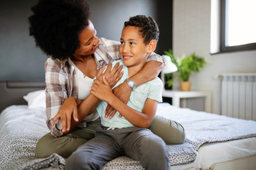 Wall Mural - Mother playing bonding hugging with her son. Happy family time.