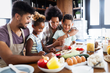 Wall Mural - happy family preparing together food in the kitchen