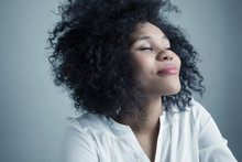 Portrait Serene Mixed Race Young Woman With Curly Black Afro Hair And Eyes Closed With Head Back