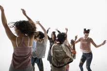 Young Women Friends Dancing Against White Background