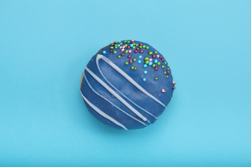 Wall Mural - Blue sweet donut on a blue background. Concept blue on blue, mnimalism, sweet desserts. copy space blue background