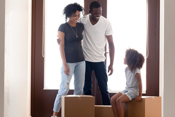 Wall Mural - Excited black family moving to new home with daughter