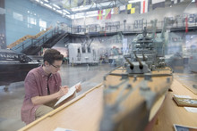 Boy Sketching Model Naval Ship Exhibit In War Museum