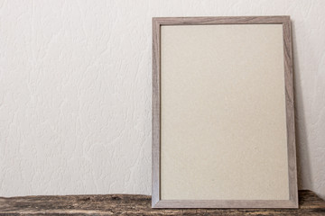 empty photo frame on wooden background with place for text