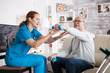 © DC Studio - Senior man in nursing home with doing physical therapy