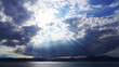 © Artem - dramatic sky, dark clouds on a blue sky, the rays of the sun pass through the clouds in lines. glow of heaven at sea. ocean