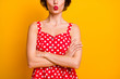 Cropped photo of pretty girlish lady arms crossed hide facial expression only send plump lips air kisses wear retro style dotted red white dress isolated yellow color background