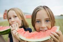 Portrait Of Girls Eating Watermelon Outdoors