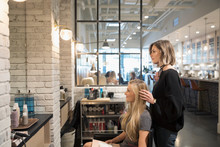 Female Hair Stylist And Customer Talking, Planning In Hair Salon