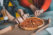 © zinkevych - Close up of pizza being taken by pieces