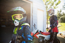 Portrait Confident Girl Wearing Motorbike Helmet In Sunny Driveway