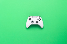 White Gamepad On A Green Background. Concept Game On The Console, Computer Games. Flat Lay, Top View.