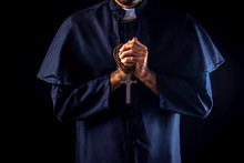 The Priest Holds The Cross On Black Background For Halloween Concepts