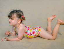 Cute Little Girl Playing On The Beach