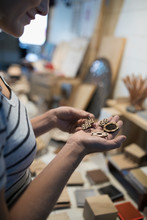 Female Craftswoman Examining Laser Cut Wood Pieces