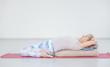 © Ermolaev Alexandr - Senior woman practicing yoga, lying in Reclined Butterfly exercise. Sport healthy concept