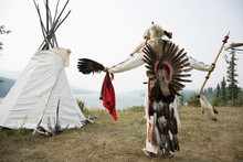Native American Indian In Traditional Clothing Outside Teepee