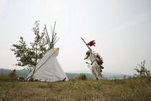 Native American Indian Dancing In Traditional Clothing Outside Teepee