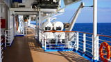 Fototapeta  - walk deck on a cruise ship. safety on the ship, lifeboat, liferafts, lifebuoys. liferaft station. blue ocean. white ship in the blue ocean. large cruise ship