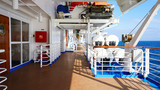 Fototapeta  - walk deck on a cruise ship. safety on the ship, lifeboat, liferafts, lifebuoys. liferaft station. blue ocean. white ship in the blue ocean. large cruise ship