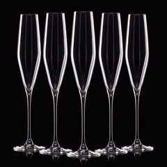 Wall Mural - Set of empty luxury champagne glasses in a row isolated on a black background